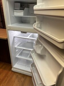A spotless and thoroughly cleaned empty refrigerator interior, a service provided by Maid In Indy in Indianapolis, IN.