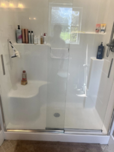 A spotless glass shower enclosure in a clean bathroom by Treadway's Cleaning Services in Spencer, IN