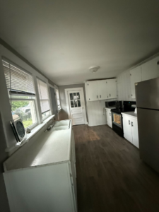 A spotless kitchen with white cabinets and appliances after a professional cleaning by Sophia's Cleaning service LLC in Manassas, VA.