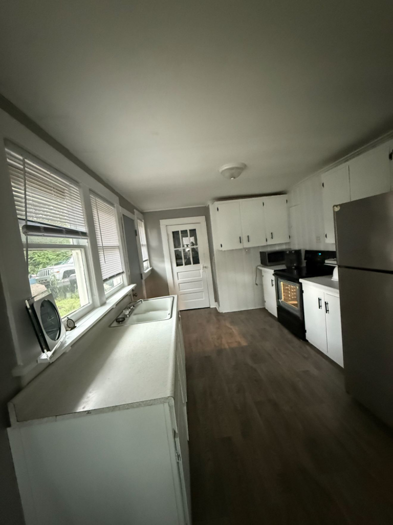 A spotless kitchen with white cabinets and appliances after a professional cleaning by Sophia's Cleaning service LLC in Manassas, VA.