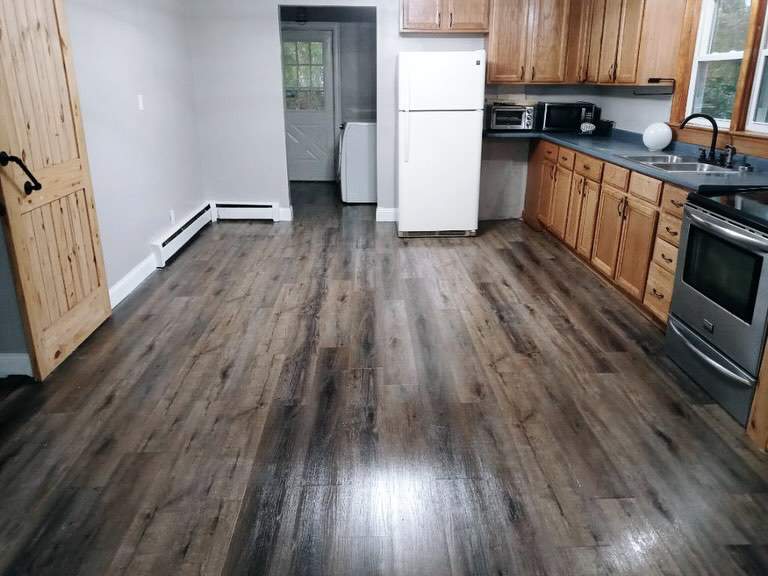 A spotless kitchen with clean wood-look laminate flooring by Sanchez Cleaning Service, LLC in San Antonio, TX.