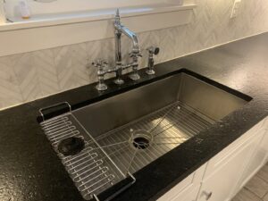 A spotless kitchen sink with a decorative faucet and clean backsplash, showcasing the detailed cleaning by Simply Clean Jax in Jacksonville, FL.