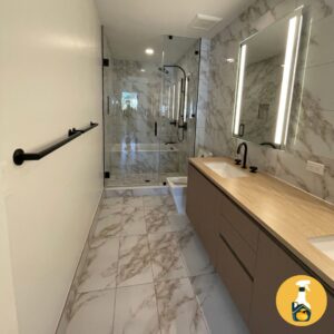 A spotless modern bathroom with marble tiles and a large shower, cleaned by The Prime Cleaner in Miami, FL.