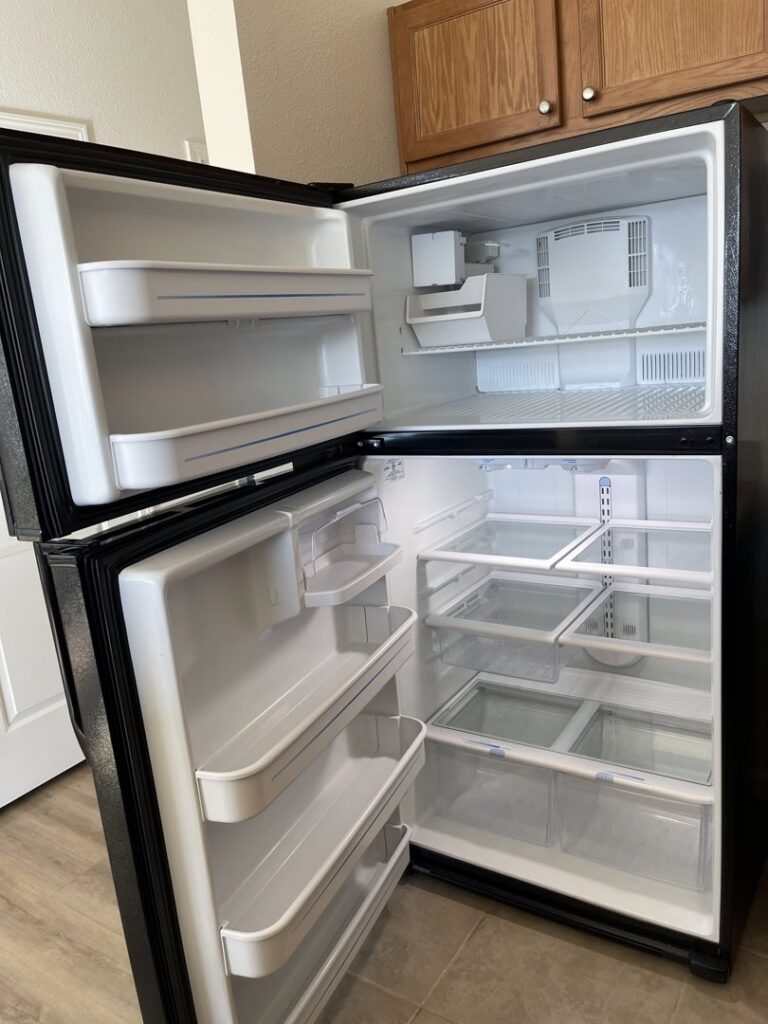 A spotless and empty refrigerator interior with clean shelves, showcasing meticulous cleaning by 307 Maid in Cheyenne, WY.