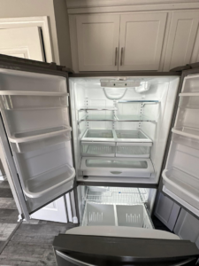 The spotless interior of an empty refrigerator, demonstrating thorough cleaning by CLEAN That SHEET LLC in Jacksonville, FL.