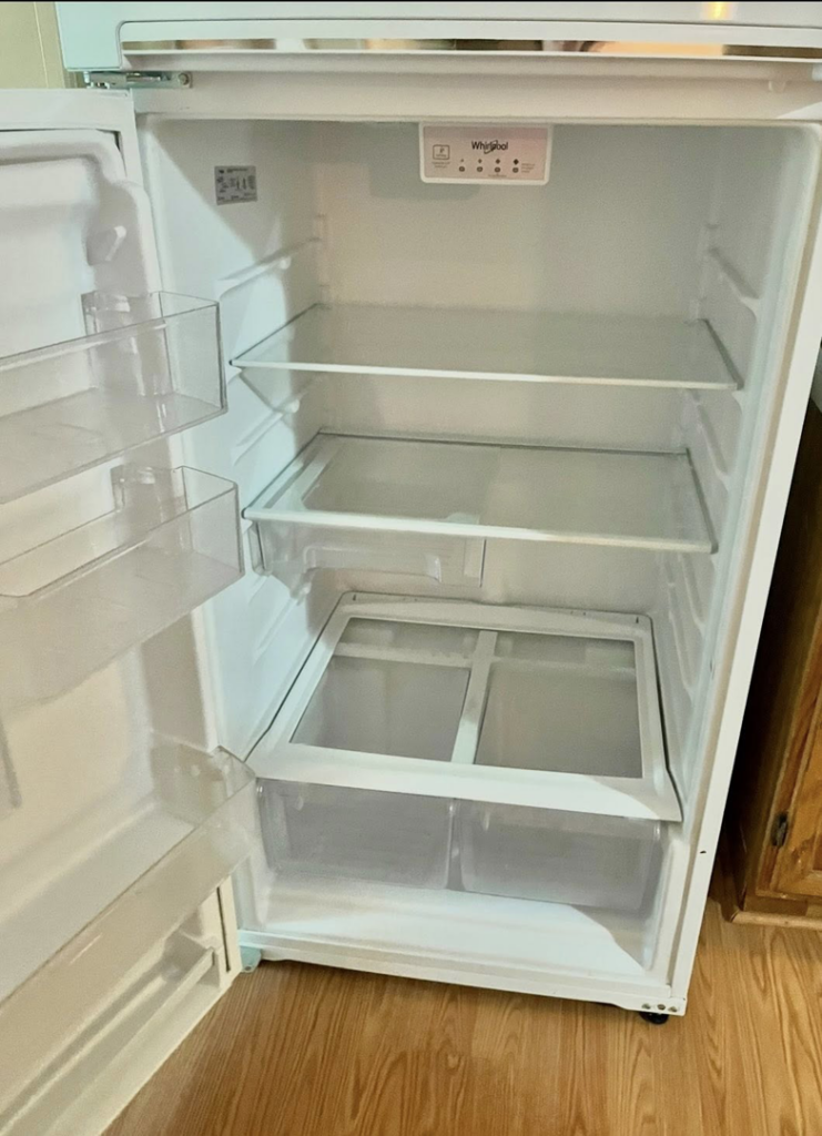 The spotless interior of a refrigerator, professionally cleaned by Mama's Touch Cleaning Service LLC in Evansville, IN.