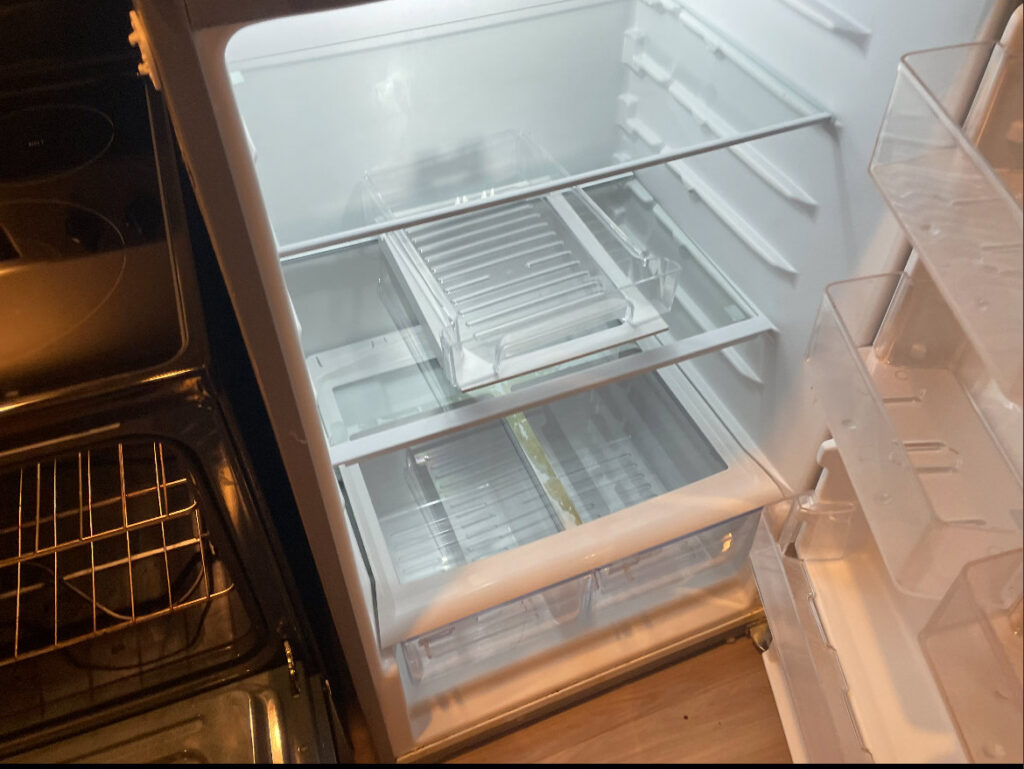The spotless interior of an empty refrigerator, demonstrating thorough appliance cleaning by Merriweather Cleaning and Laundry in Vancouver, WA.