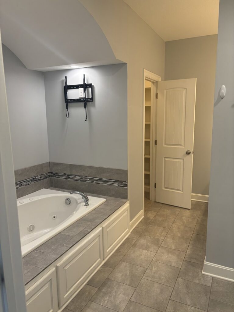 A spotless residential bathroom featuring a large tub and tiled floor, cleaned by Uniquely Clean Professional Services in Kansas City, MO.