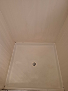 A spotless shower pan after professional cleaning services by Veter Clean in Gilbert, AZ.