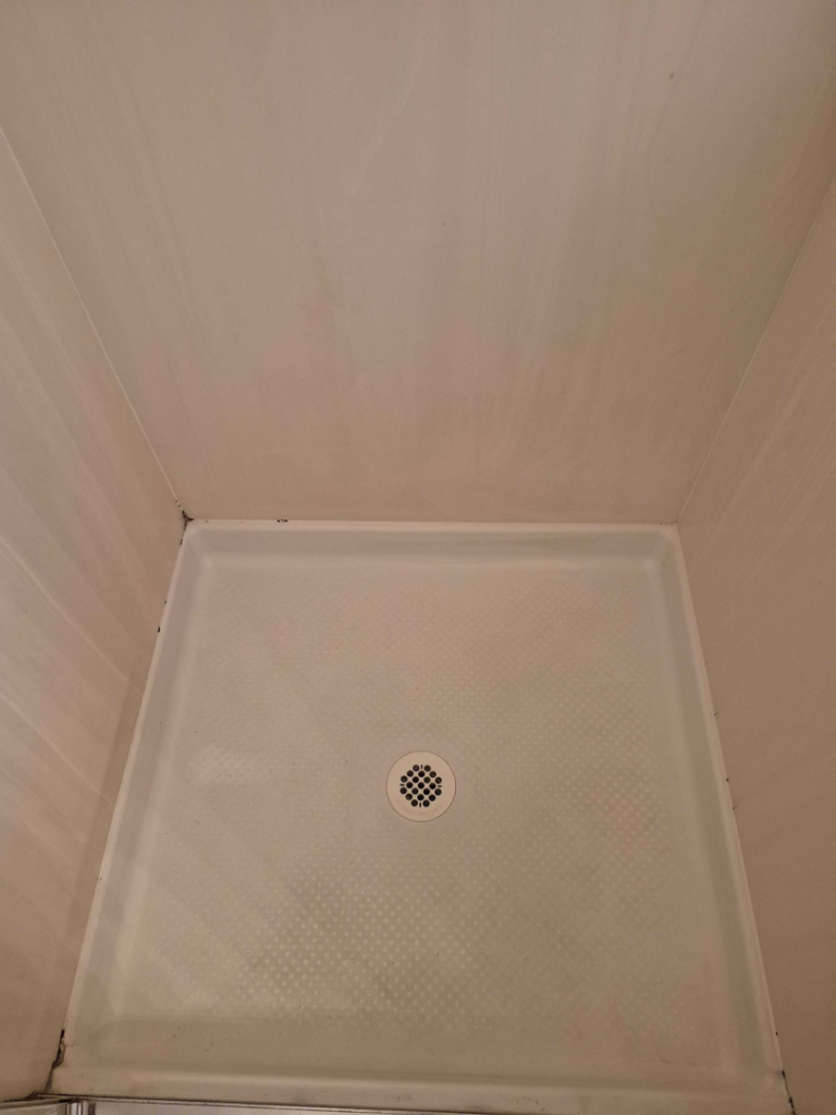 A spotless shower pan after professional cleaning services by Veter Clean in Gilbert, AZ.