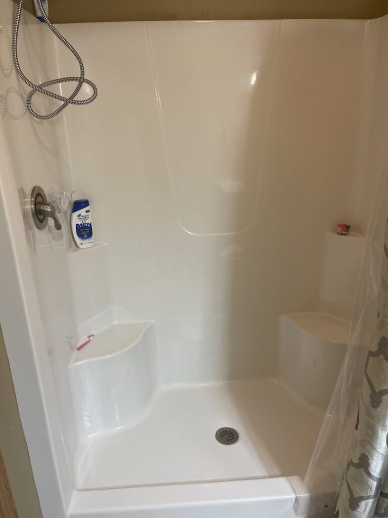 A spotless and well-maintained shower stall after professional cleaning by Wilkie Wonders Cleaning in Akron, OH.