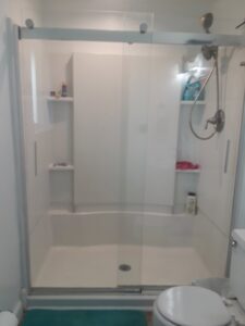 A spotless shower with a clear glass door after professional cleaning by Ady's Housekeeping in Yakima, WA