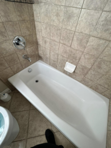 A spotless white bathtub in a tiled bathroom after professional cleaning by Superior Quality Cleaners in Sacramento, CA