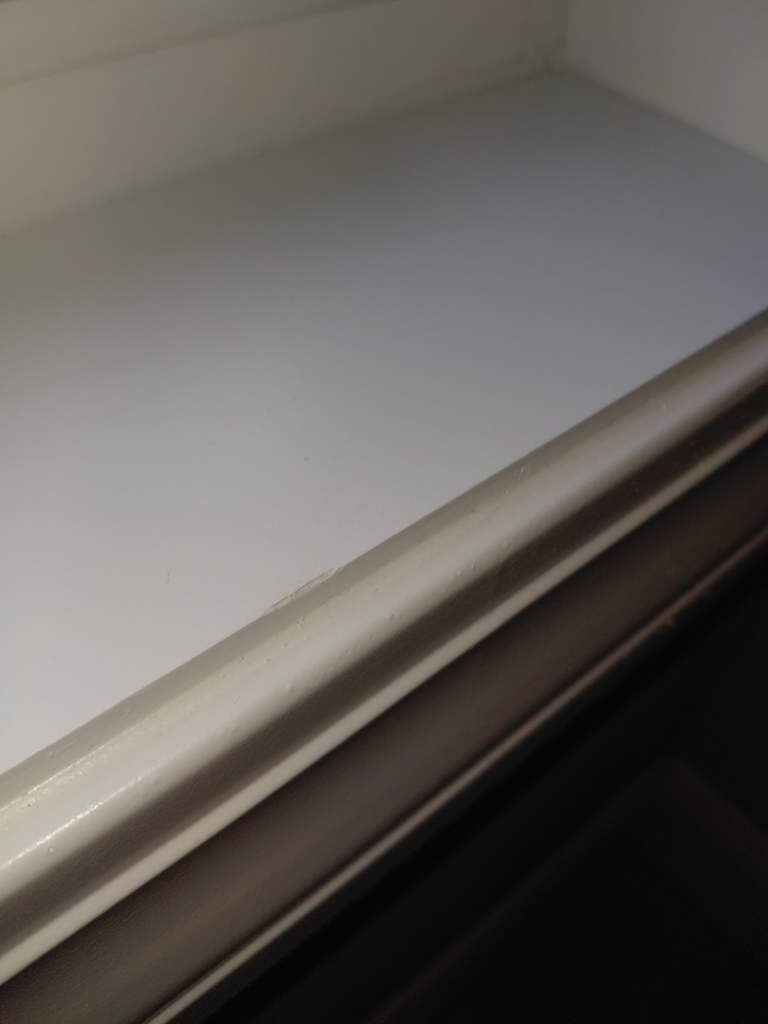 A close-up of a spotless window sill after professional cleaning by White Lotus Cleaning Services LLC in Nashua, NH.