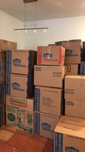 Neatly stacked moving boxes from Lowe's and U-Haul inside a room, indicating a recent move by Academy Movers in Gilbert, AZ.