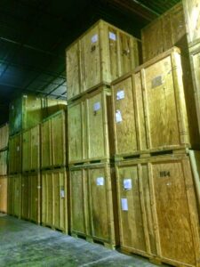 Tall stacks of wooden storage crates in the warehouse of N. L. Wilson Moving and Storage in Olathe, KS.