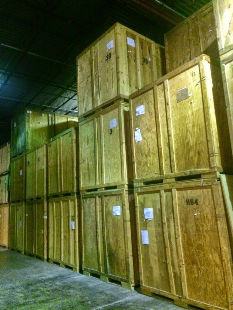 Tall stacks of wooden storage crates in the warehouse of N. L. Wilson Moving and Storage in Olathe, KS.