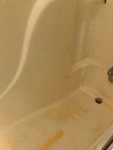 A stained and dirty bathtub with visible discoloration before cleaning by RA Cleaning Services in Brockton, MA.