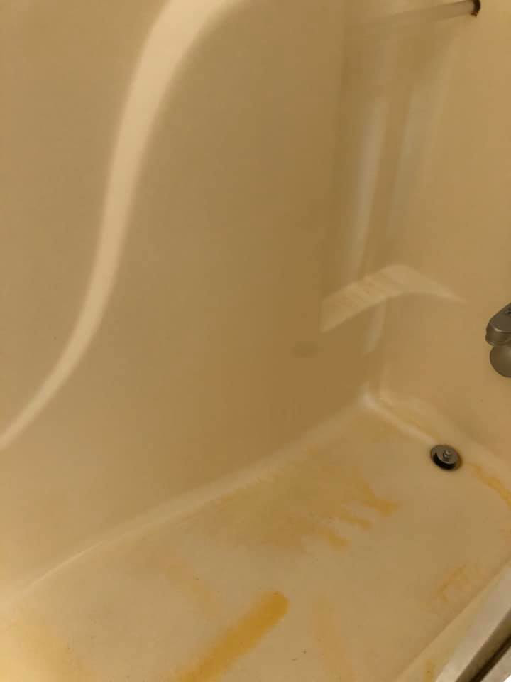 A stained and dirty bathtub with visible discoloration before cleaning by RA Cleaning Services in Brockton, MA.
