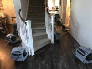 Air movers drying a staircase and hallway after water damage by Best Dry Flood and Mold Specialists, Inc. San Diego, CA