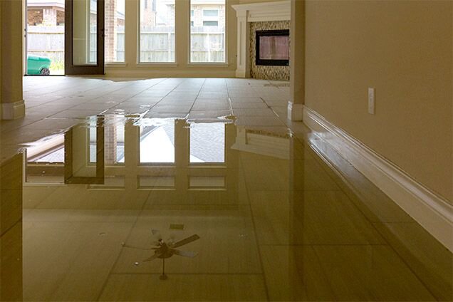 A flooded room with significant standing water on the floor, indicating severe water damage, by Doctor Fix-It in Denver, CO.