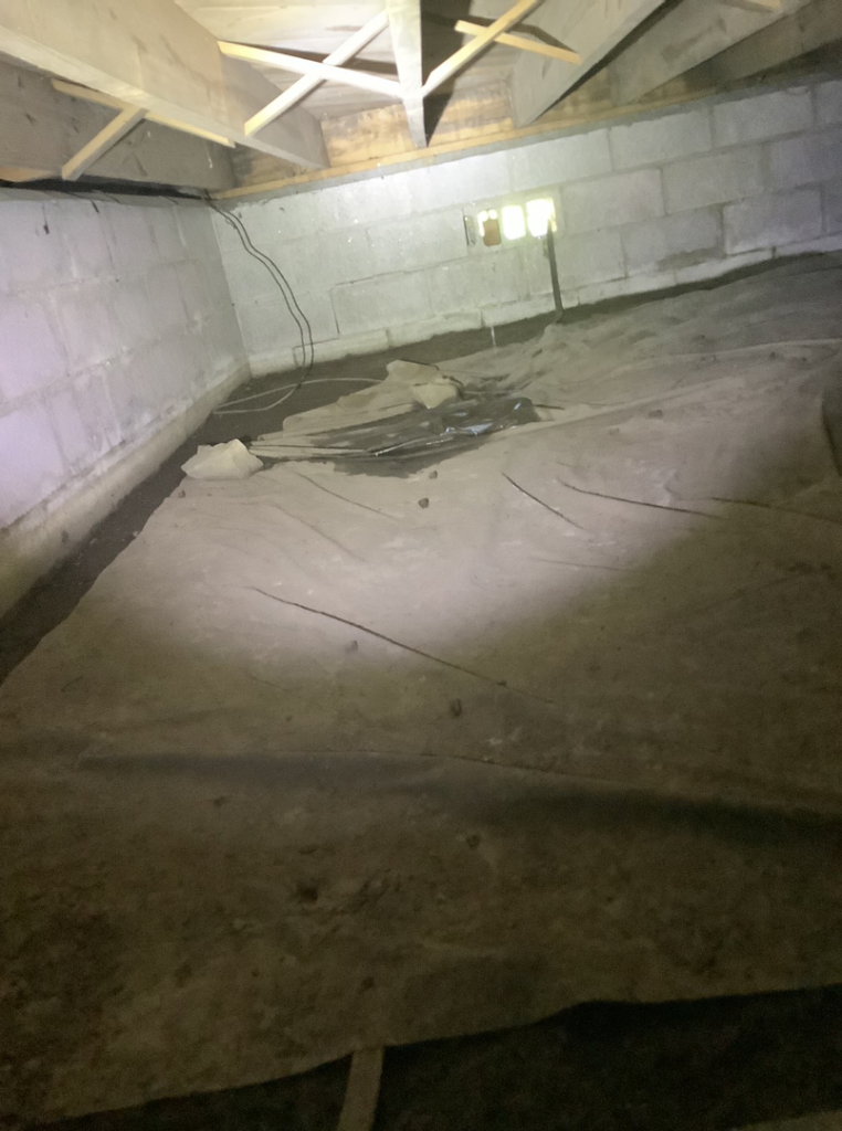 Standing water visible on a crawlspace vapor barrier, a clear sign of water damage addressed by Allied Foundation & Crawlspace Solutions in Decatur, AL.