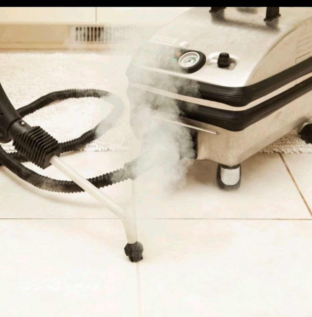 A professional steam cleaner machine operating on a tiled floor, demonstrating cleaning services by D A E S Cleaning LLC in Billings, MT.