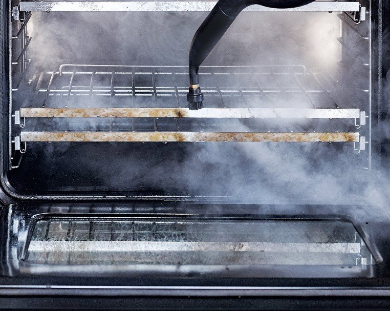A steam cleaner being used to clean the interior and racks of an oven by D A E S Cleaning LLC in Billings, MT.