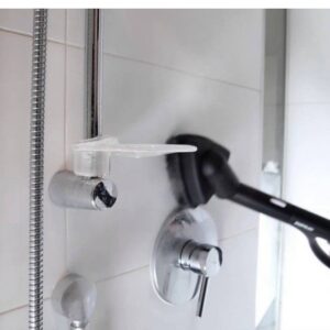 A steam cleaner being used to clean a shower fixture and tiled wall in a bathroom by D A E S Cleaning LLC in Billings, MT.