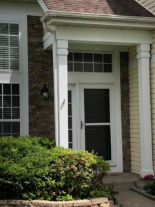 A close-up view of stone veneer paired with light yellow siding, completed by A&D Exteriors in Naperville, IL.