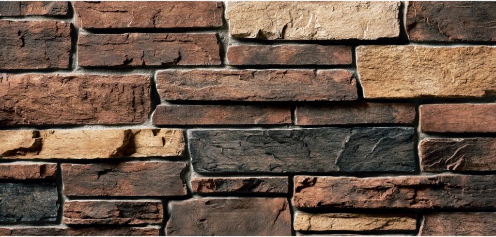 Close-up of a rustic stone veneer siding texture, a service offered by Eastern Stucco Restorations in Rock Hill, SC.