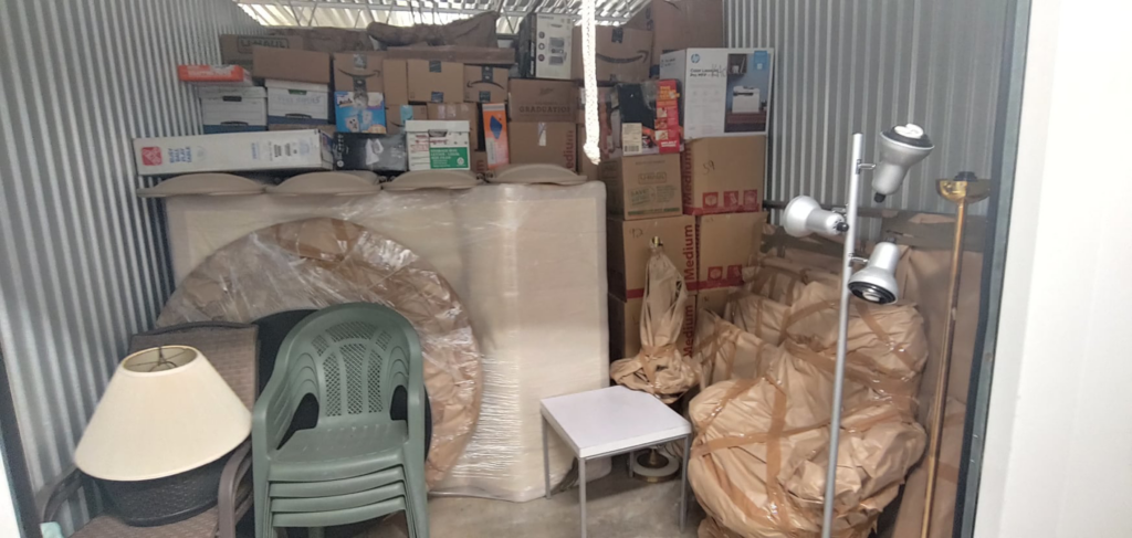 A storage unit packed with household items, showcasing Prime Moving Center's organization in Pittsburgh, PA.