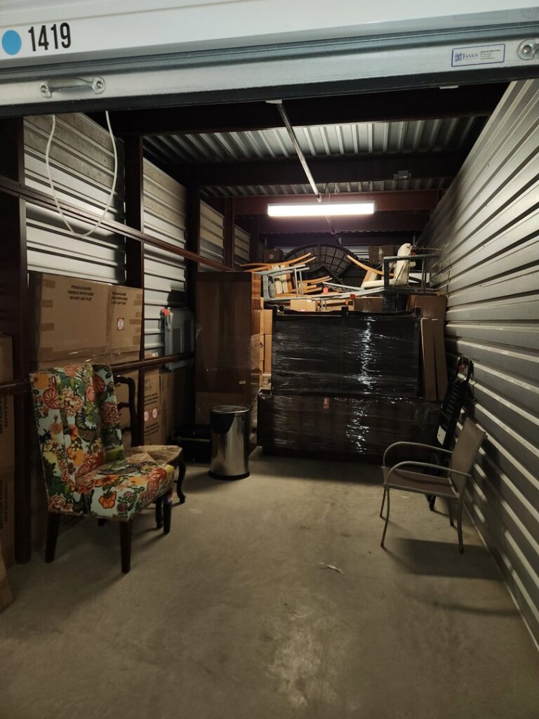 A storage unit packed with various household items and furniture, handled by Ang Moving Co in Dallas, TX