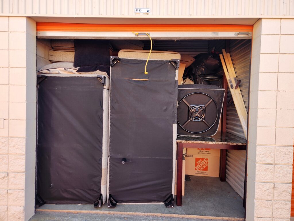 A storage unit packed with furniture and boxes, handled by Family Movers 615 LLC in Goodlettsville, TN.