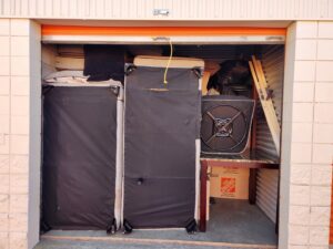 A storage unit packed with furniture and boxes, handled by Family Movers 615 LLC in Goodlettsville, TN.