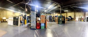 A wide view of the J.Gentle Van Lines storage warehouse, filled with numerous wrapped and stacked items in Elizabeth, NJ.