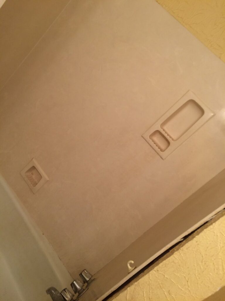 A stripped-down bathtub area with bare walls after old surround removal by Rayshawn's Home improvement & Construction work in Bossier City, LA.