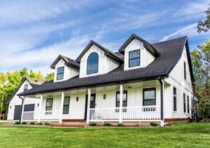 A stunning white residential home featuring modern vertical siding and black trim installed by Xtreme Exteriors in Rogers, AR.