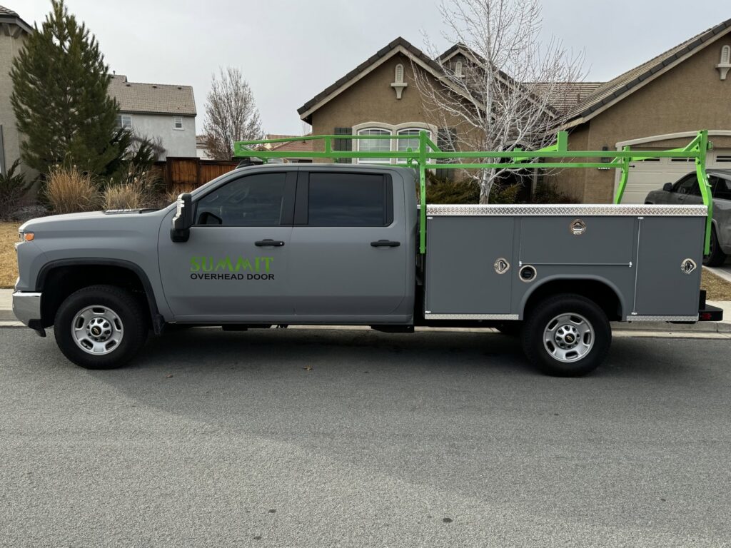 A grey service truck with Summit-Overhead-Door branding and ladder rack, ready for jobs in Sparks, NV.