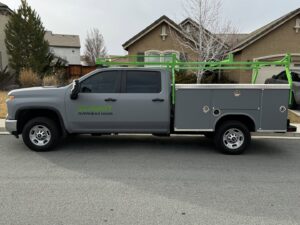 A grey service truck with Summit-Overhead-Door branding and ladder rack, ready for jobs in Sparks, NV.