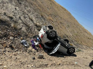 A white SUV rolled over on a rocky hillside, indicating an accident recovery job for Gem State Towing and Recovery in Caldwell, ID.