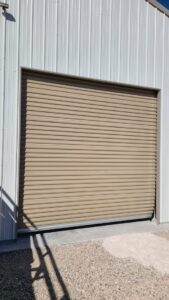 A tan commercial rolling garage door installed or serviced by USA Doors in Doral, FL.