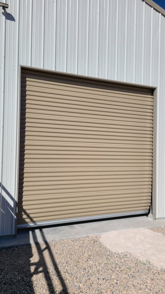 A tan commercial rolling garage door installed or serviced by USA Doors in Doral, FL.