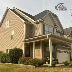 A beautiful home exterior featuring tan vinyl siding installed by Ultra Roofing in Cary, NC