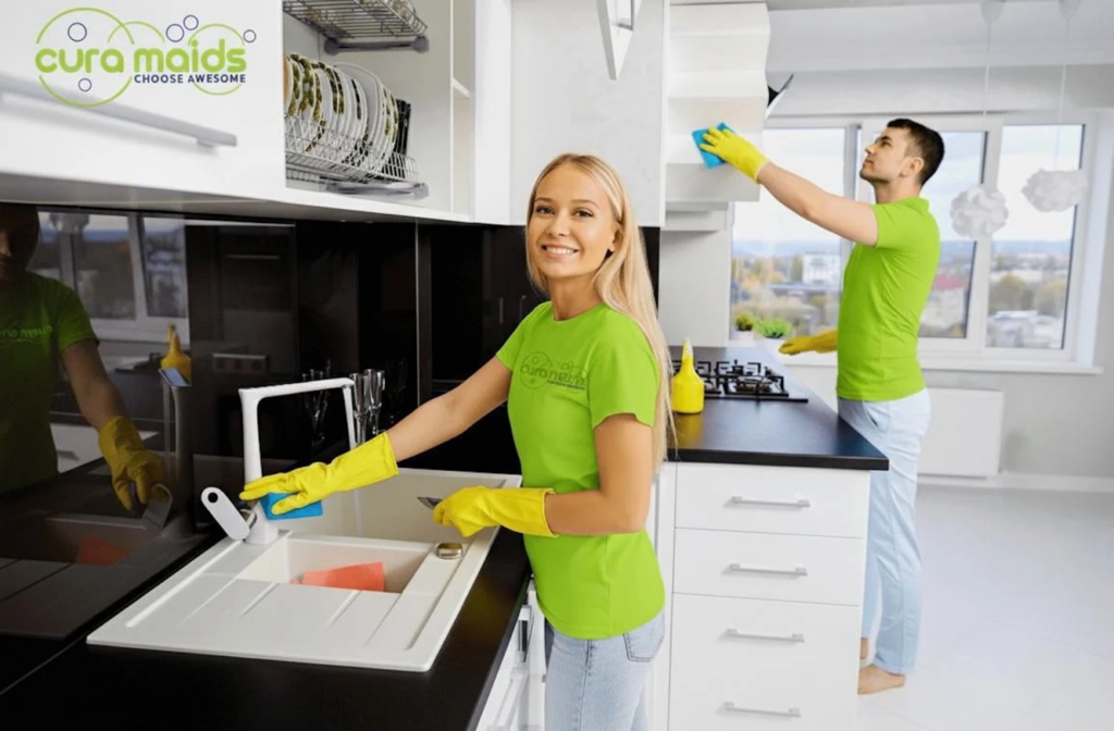 A team from Cura Maids performing a thorough kitchen cleaning service in Raleigh, NC.