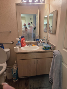 A team of house cleaners in protective gear in a bathroom, ready for work at Expert Cleaners LLC in Jacksonville, FL.
