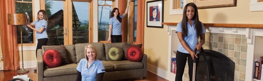 A team of professional cleaners in uniform working in a living room at Certified Apartment Cleaners in Little Rock, AR