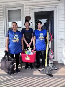 A team of professional house cleaners from Bivian's Cleaners LLC standing with their supplies in Trenton, NJ.