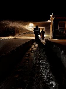 A team performing snow removal with a snow blower and shovel for 10.7 Property Solutions LLC in South Bend, IN