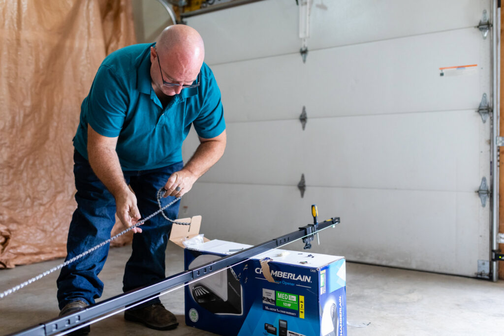 A technician assembling a Chamberlain garage door opener chain during an installation by Bob McDonald Garage Door LLC in Columbus, NE.